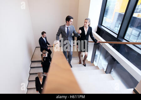 Business people walking on stairs of modern building Stock Photo