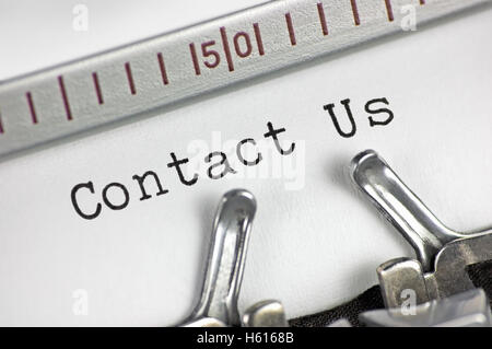 Typewriter detailed macro closeup typing text Contact Us, large detail vintage customer service metaphor concept studio shot Stock Photo