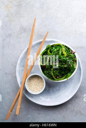 Traditional Japanese appetizer salad served in a small bowl and chopsticks Stock Photo