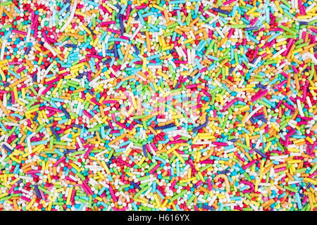 Sugar sprinkles  glaze of all colors of the rainbow in the form of small balls and sticks for decoration of donuts and cakes. Ma Stock Photo