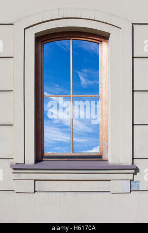 Wooden window in which the blue sky is reflected  in the old vintage house. Glass isolated with patch Stock Photo