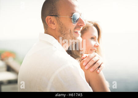 happy just married young wedding couple celebrating and have fun at beautiful beach sunset Stock Photo
