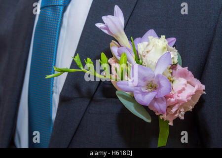 A small bouquet of flowers in the groom's suit Stock Photo