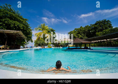 Young woman relaxing in the swimming pool Stock Photo - Alamy