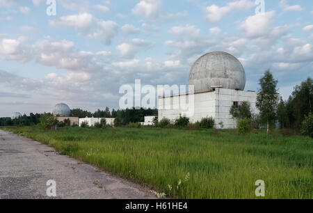 Russian military base in the forest with several big domes of a radar antenna Stock Photo