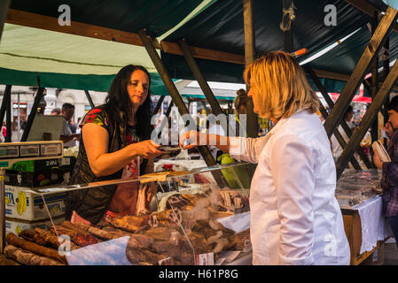 Woman tasting home produced ham, Producers' artisan market, Ban Jelacic Square, Zagreb, Croatia Stock Photo