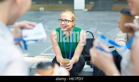 Cheerful colleagues meeting for coffee break. Stock Photo