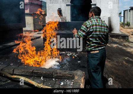 Chichicastenango, Guatemala - April 26, 2014: Maya man performing a ritual in the cemetery of the town of Chichicastenango Stock Photo
