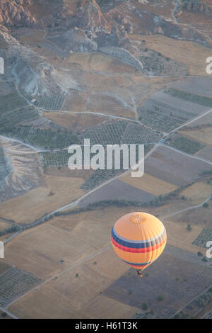 Color image of a hot air balloon flying in Cappadocia, Turkey, at sunrise. Stock Photo