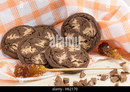 Chocolate chip brown cookies with sugar on orange tablecloth Stock Photo
