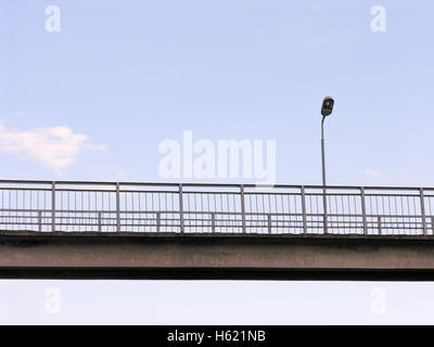 Lantern on the bridge above the track at a small railway station Stock Photo