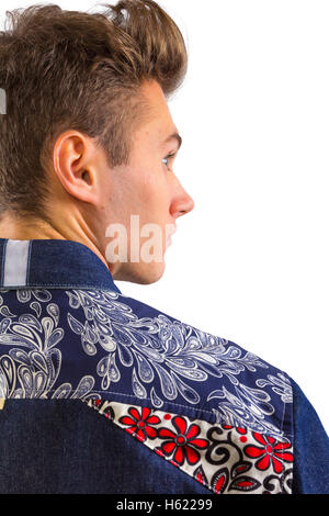 Young blond stylish man in blue denim shirt with floral pattern detail, product catalog catalogue shot, looking over shoulder Stock Photo