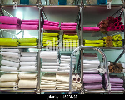 Towels, mats, robes and other home bath wear on shelves made of Egyptian Cotton Stock Photo