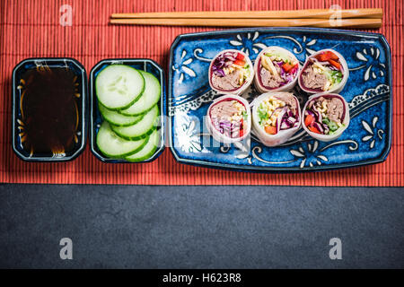 Sushi bites overhead view on bamboo mat Stock Photo