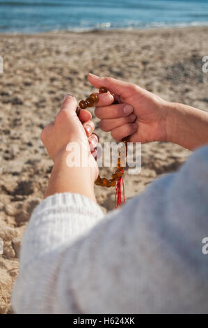 girl holding a rosary Stock Photo