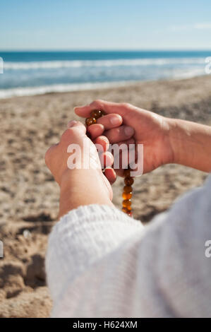 girl holding a rosary Stock Photo