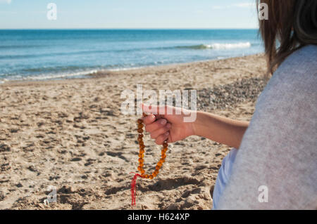 girl holding a rosary Stock Photo