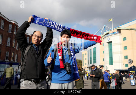 Fans hold a Chelsea and Manchester United half scarf outside Stamford Bridge before the Premier League match at Stamford Bridge, London. Stock Photo