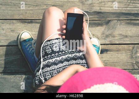 The girl is holding smartphone Stock Photo