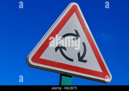 roundabout road sign on blue sky Stock Photo
