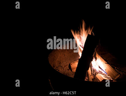 Fire Pit Flames in a campsite fire ring Stock Photo