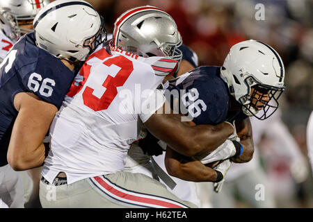 October 21, 2016 - University Park, Pennsylvania, USA - October 22nd, 2016: Ohio State Buckeyes defensive tackle Davon Hamilton (53) tackles Penn State Nittany Lions running back Saquon Barkley (26) during NCAA football game action between the Ohio State Buckeyes and the Penn State Nittany Lions at Beaver Stadium, University Park, PA. Photo by Adam Lacy/Zuma Wire (Credit Image: © Adam Lacy via ZUMA Wire) Stock Photo