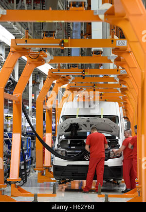 Wrzesnia, Poland. 24th Oct, 2016. Employees assembling a Volkswagen Crafter van at the new Volkswagen Nutzfahrzeuge (Commercial Vehicles, VWN) factory in Wrzesnia, Poland, 24 October 2016. The factory was built in only two years. Volkswagen Commercial Vehicles invested roughly 800 million Euro in the 220 hectar area. Up to 3,000 employees are said to assemble the new Crafter at the factory. PHOTO: RAINER JENSEN/dpa/Alamy Live News Stock Photo
