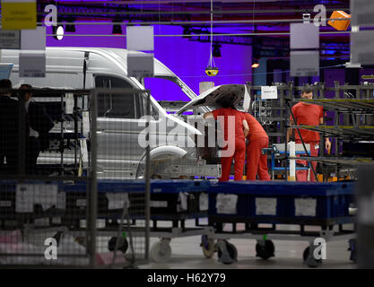 Wrzesnia, Poland. 24th Oct, 2016. Employees assembling a Volkswagen Crafter van at the new Volkswagen Nutzfahrzeuge (Commercial Vehicles, VWN) factory in Wrzesnia, Poland, 24 October 2016. The factory was built in only two years. Volkswagen Commercial Vehicles invested roughly 800 million Euro in the 220 hectar area. Up to 3,000 employees are said to assemble the new Crafter at the factory. PHOTO: RAINER JENSEN/dpa/Alamy Live News Stock Photo