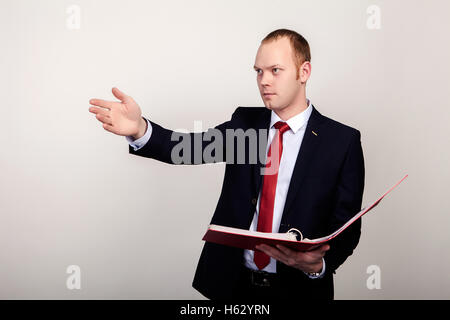 Full body portrait of happy smiling business man with red folder, isolated over white background Stock Photo