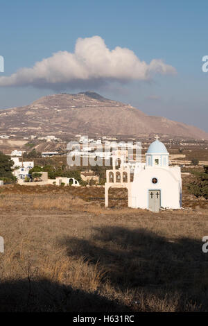 A cloud hangs over the highest point on Santorini Island, Greece. Stock Photo