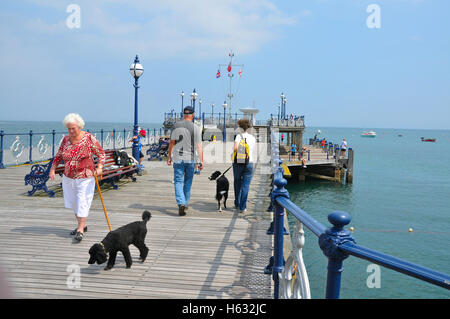 People with dogs walking on Swanage Pier in Dorset, England. Stock Photo