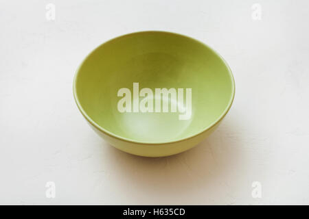 one green bowl on white plastering plate Stock Photo