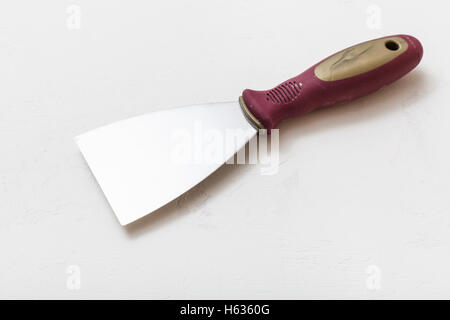 metal spatula with plastic handle on concrete floor Stock Photo