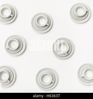 food concept - top view of several white cups and saucers on white background Stock Photo