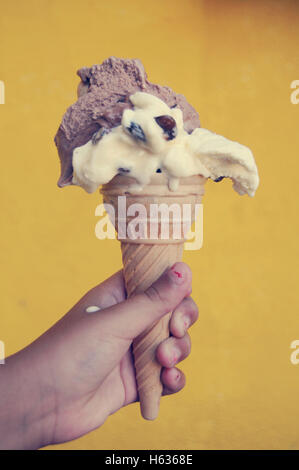 child hand holding a  ice cream scoop on cones Stock Photo