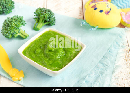 Baby food: organic green broccoli puree Stock Photo