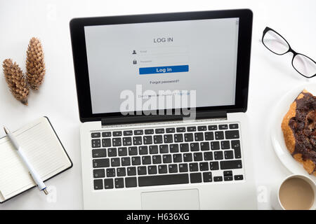 Open laptop with a log in on it, glasses, office supplies Stock Photo