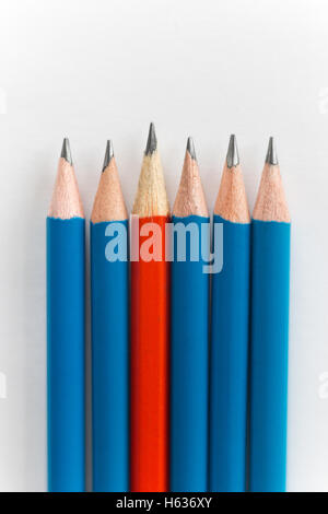 Simple pencils, one red among the blue Stock Photo