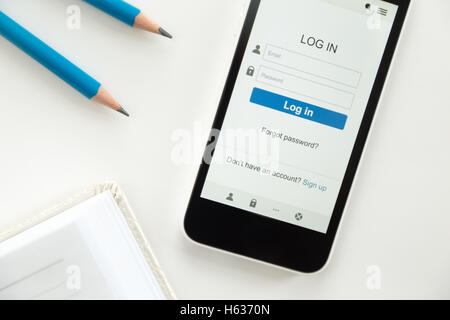 Top view of a phone on desk, log in on screen Stock Photo