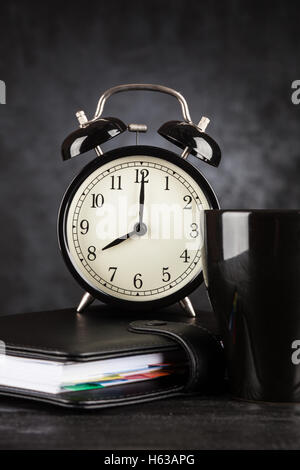 Alarm clock and a cup of coffee Stock Photo
