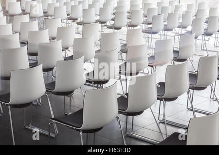 Empty white chairs in contemporary conference hall with Stock Photo