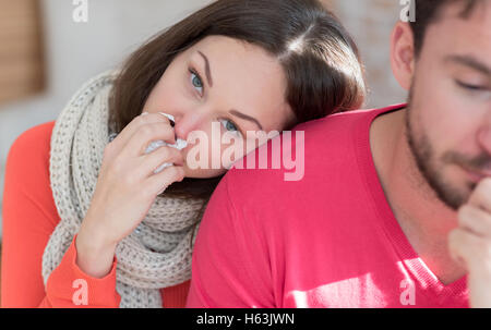 Sick depressed woman leaning on the shoulder of her boyfriend Stock Photo