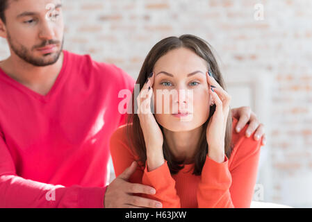 Depressed attractive woman pressing her hands to the head Stock Photo