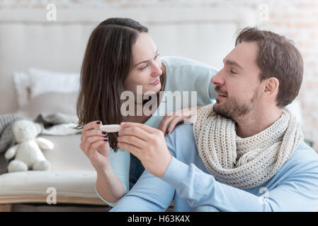 Pleasant delighted couple looking at each other Stock Photo
