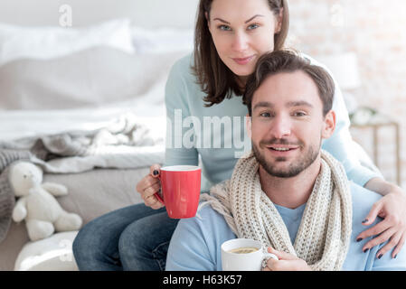 Joyful young couple having tea together Stock Photo