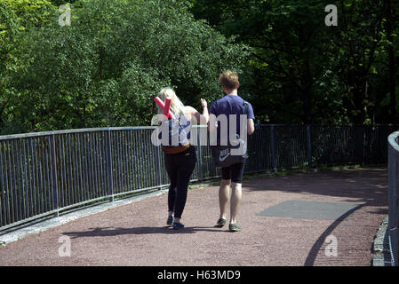 young couple walking happy on bridge pedestrian  Glasgow, Scotland Stock Photo