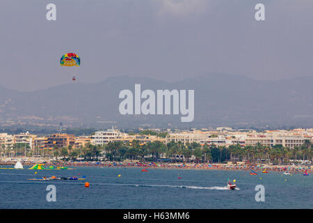 Two people parasailing in the sea at summer, assisted by a boat Stock Photo