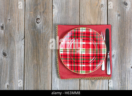 Overhead view of a festive Christmas dinner setting and cloth place mat on top of rustic wood Stock Photo