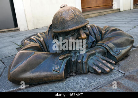 A bronze statue representing a street worker emerging from a manhole. On a street in the city centre of Bratislava, the capital