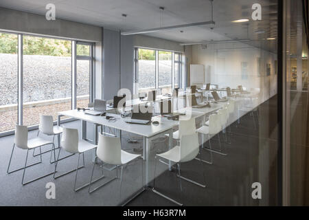 Empty white chairs in contemporary conference hall with Stock Photo